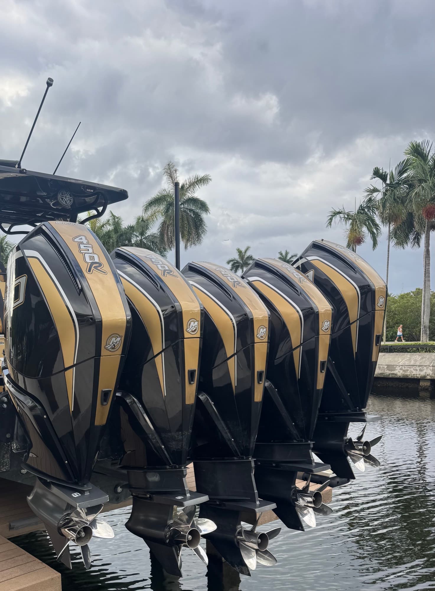 Five black and gold Mercury Racing 450R outboards on the back of the Midnight Express